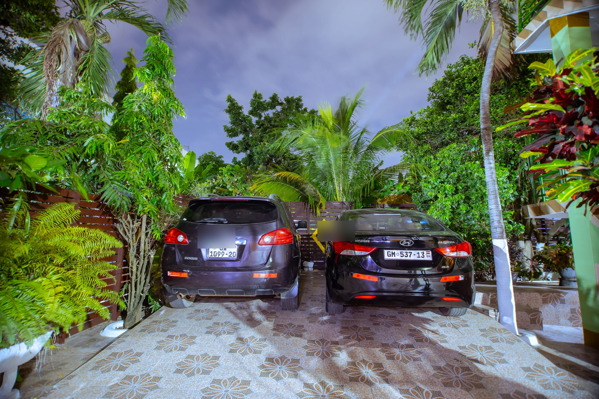 Guest parking area at Sarpomaa Cottage with registration plates protected